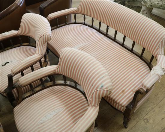 An upholstered settee on mahogany frame and two tub chairs W.140cm